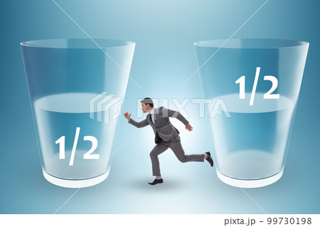 Businessman in half empty half full glass concept 99730198