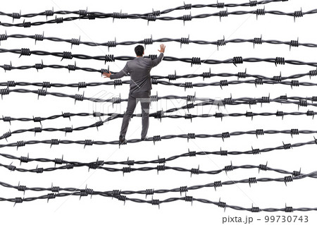 Businessman in barbed wire concept Businessman in barbed wire concept 99730743