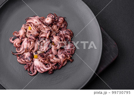 Delicious marinated octopus babies with lemon, salt and spices 99730795