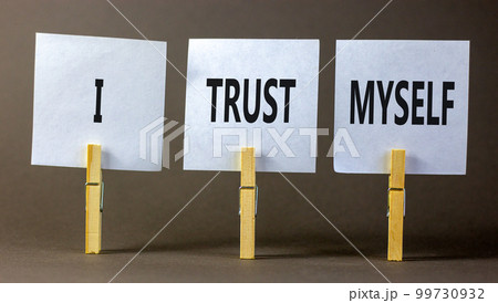 I trust myself symbol. Concept words I trust myself on white papers on wooden clothespins. Beautiful grey table grey background. Business, psychological and I trust myself concept. Copy space. 99730932