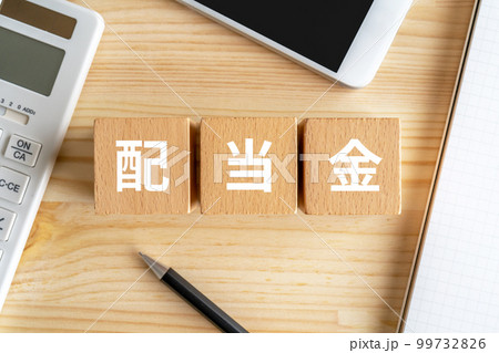 配当金と書かれたブロック、電卓、スマホ、ノート 99732826
