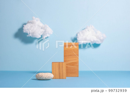 Podiums made of wooden figures and glass, blue background with white clouds, minimalist style 99732939
