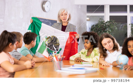 students listen to the teacher who talks about Mexico 99738194