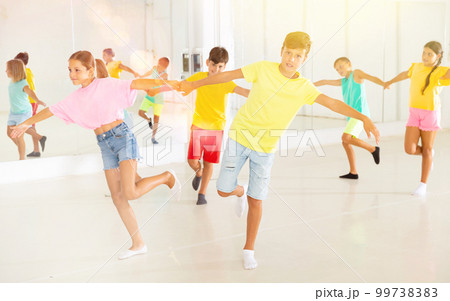 Boys and girls enjoying active dance in studio Boys and girls enjoying active dance in studio 99738383