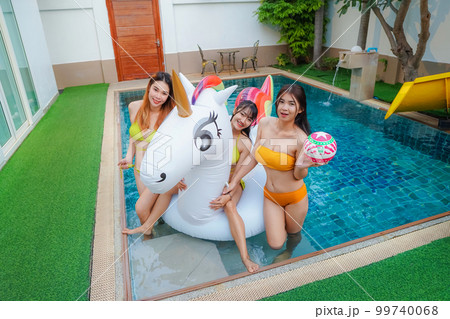 Asian three young sexy woman wearing a yellow bikini Playing in the pool at Pool Villa 99740068