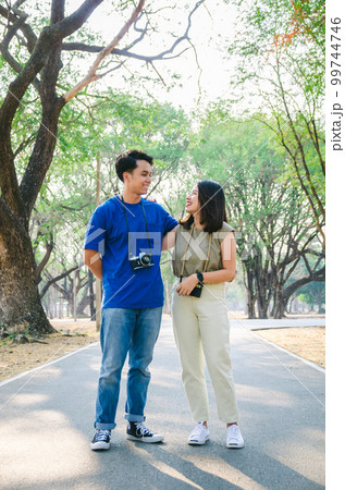 Asian couple is standing in park with happiness moment 99744746