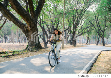 Asian young girl is biking on bicycle 99744747