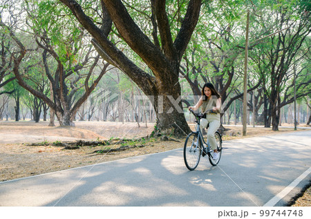 Asian young girl is biking on bicycle 99744748