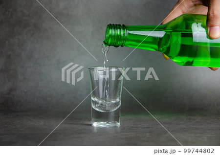 soju is pouring on glass, selective focus 99744802