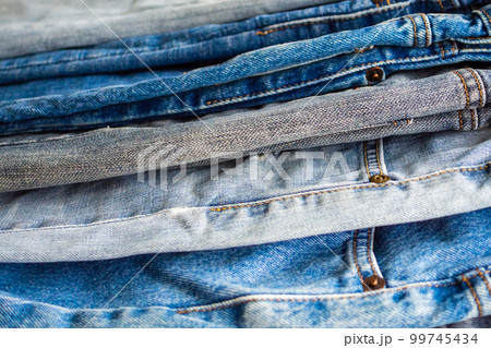 denim blue jeans stack texture background closeup 99745434