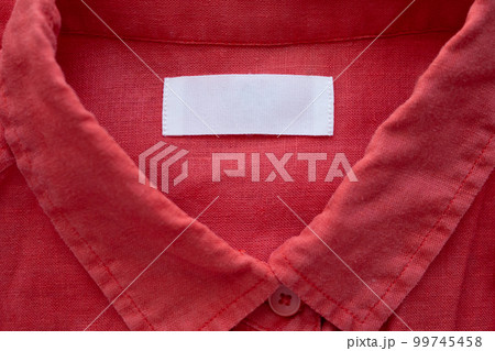 White blank clothing tag label on red linen shirt fabric texture background White blank clothing tag label on red linen shirt fabric texture background 99745458