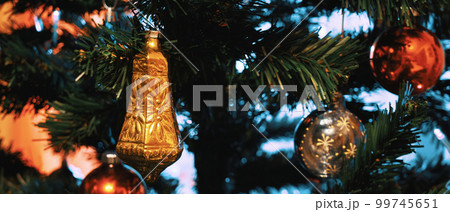 Decorated Christmas tree closeup. Widescreen image of an artificial Christmas tree with decorations 99745651
