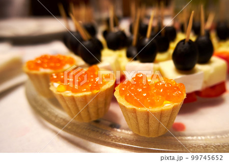 Tartlets with red caviar close-up. Seafood and their health benefits Tartlets with red caviar close-up. Seafood and their health benefits 99745652