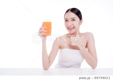Portrait of Beautiful young woman holding orange juicy and smile isolated on white background. Portrait of Beautiful young woman holding orange juicy and smile isolated on white background. 99749021