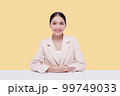 Young businesswoman in a cream suit. Isolate on a pastel yellow background. 99749033