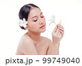 Beauty woman perfect face fresh clean skin portrait isolated on white. Beautiful asian girl holding plumeria flowers with make up and beauty healthy skin color lips red and hair portrait. Spa and skin 99749040