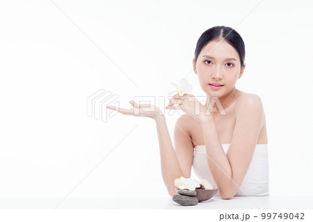 Beauty woman perfect face fresh clean skin portrait isolated on white. Beautiful asian girl holding plumeria flowers with make up and beauty healthy skin color lips red and hair portrait. Spa and skin Beauty woman perfect face fresh clean skin portrait isolated on white. Beautiful asian girl holding plumeria flowers with make up and beauty healthy skin color lips red and hair portrait. Spa and skin 99749042