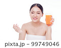 Portrait of Beautiful young woman holding orange juicy and smile isolated on white background. 99749046