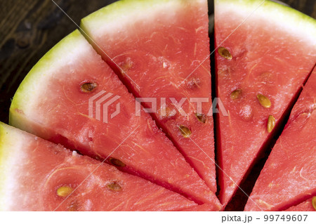 Ripe red watermelon cut into pieces Ripe red watermelon cut into pieces 99749607