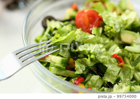Delicious vitamin fresh salad with fresh lettuce tomatoes and cucumbers Delicious vitamin fresh salad with fresh lettuce tomatoes and cucumbers 99754000