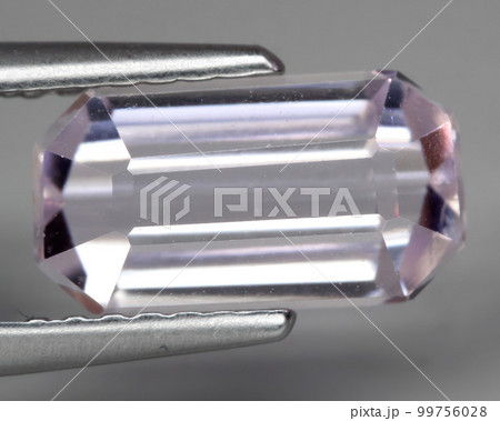 Natural gemstone pink kunzite on gray background 99756028