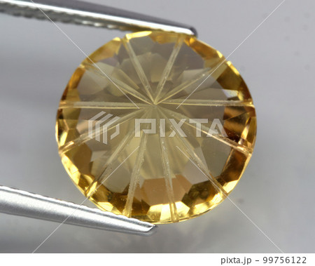 Natural gemstone yellow citrine on gray background Natural gemstone yellow citrine on gray background 99756122