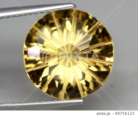 Natural gemstone yellow citrine on gray background Natural gemstone yellow citrine on gray background 99756123
