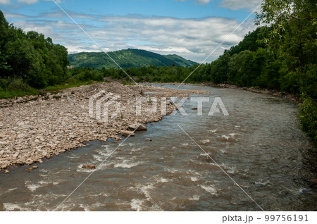 mountain river in the forest with a stone shore 99756191