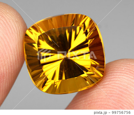 Beautiful natural citrine gemstone on a gray background Beautiful natural citrine gemstone on a gray background 99756756