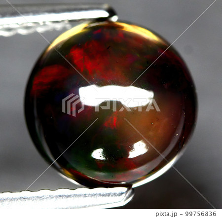 Natural beautiful gemstone opal on gray background Natural beautiful gemstone opal on gray background 99756836