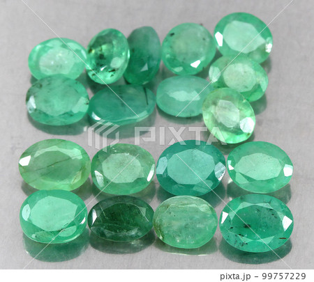 Natural gemstone green emerald on a gray background Natural gemstone green emerald on a gray background 99757229