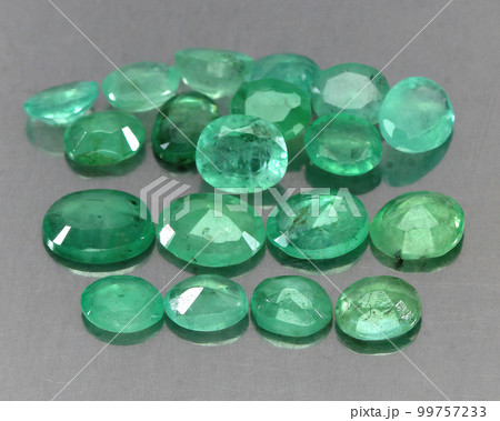 Natural gemstone green emerald on a gray background 99757233
