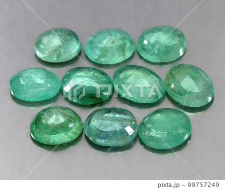Natural gemstone green emerald on a gray background 99757249