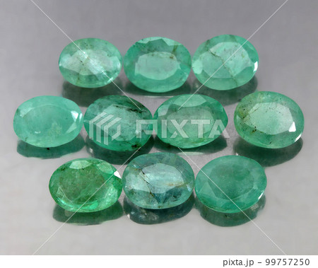 Natural gemstone green emerald on a gray background 99757250