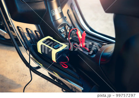 Charging battery in motorcycle for start. Charging battery in motorcycle for start. 99757297