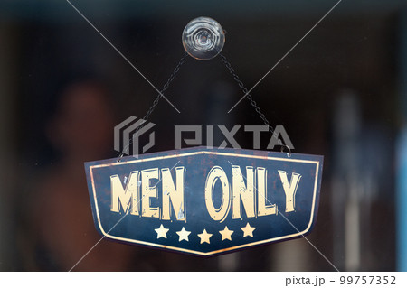 Men only sign in the window of a shop 99757352