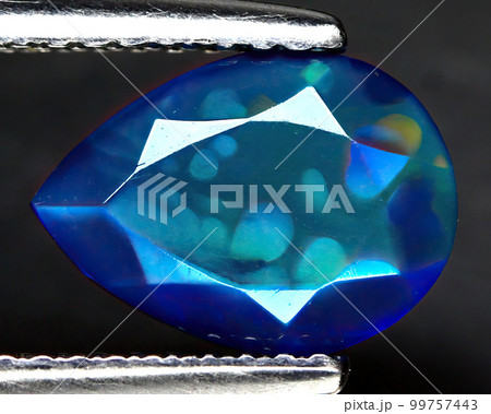 Natural beautiful gemstone opal on gray background Natural beautiful gemstone opal on gray background 99757443