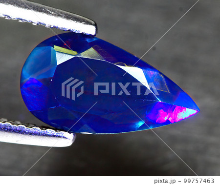 Natural beautiful gemstone opal on gray background Natural beautiful gemstone opal on gray background 99757463