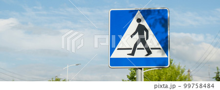 Vertical signage of crosswalk over cloudy sky, road sign pedestrian crossing. Attention road sign 99758484