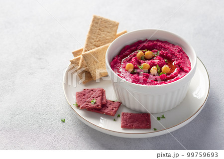beetroot hummus in white bowl with chickpeas and crackers beetroot hummus in white bowl with chickpeas and crackers 99759693