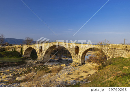 Pont Julien, roman stone arch bridge over Calavon river, Provence, France Pont Julien, roman stone arch bridge over Calavon river, Provence, France 99760268