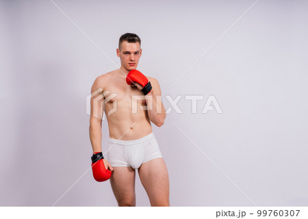 Bodybuilders boxing gloves on white background and white pants athlete model 99760307