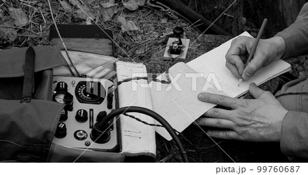 Infantry Army Soldier In World War II using Portable Radio Transceiver In Trench Entrenchment In Forest. . Headphones And Telegraph Key. Close Up Hands, Black And White Colors 99760687