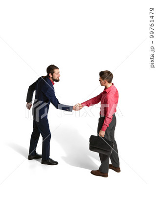 Partnership, deal. Two businessmen in official clothes shaking hands over white studio background. Isometric view. Concept of business, employment Partnership, deal. Two businessmen in official clothes shaking hands over white studio background. Isometric view. Concept of business, employment 99761479
