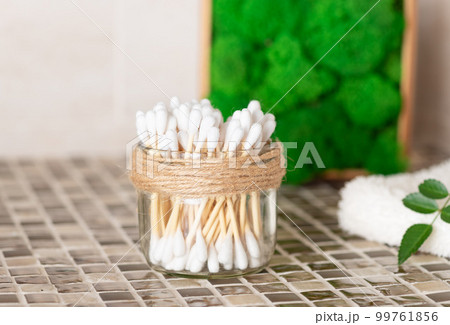 bamboo cotton swabs in glass jar on the bathroom counter. 99761856