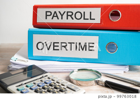 Payroll Overtime. Binder data finance report business with graph analysis in office. Payroll Overtime. Binder data finance report business with graph analysis in office. 99763018