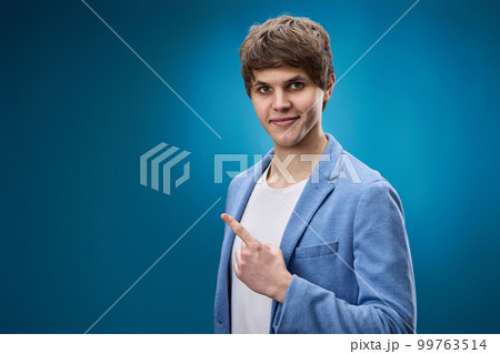 young man in jacket pointing at copy space young man in jacket pointing at copy space 99763514