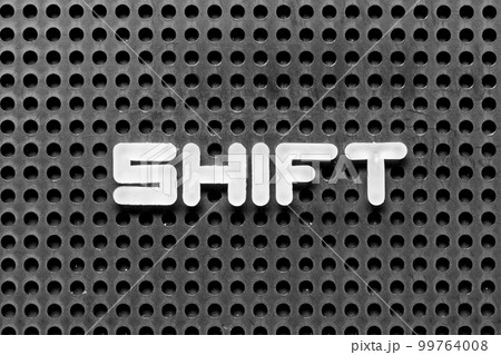 White alphabet letter in word shift on black pegboard background 99764008