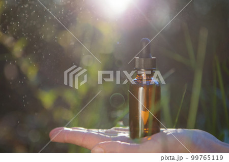 A close-up of a drug container with herbal medicine and rain droplets. A close-up of a drug container with herbal medicine and rain droplets. 99765119