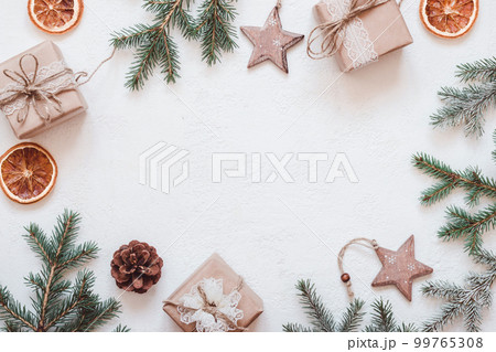 Neutral Christmas frame of fir branches, eco friendly gifts and baubles Cutout 99765308
